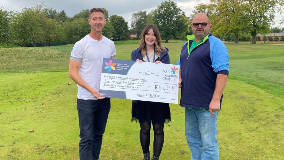 Andy and sponsor holding a giant YSHC charity cheque