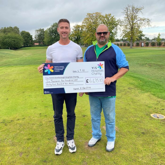 Andy and sponsor holding a giant YSHC charity cheque
