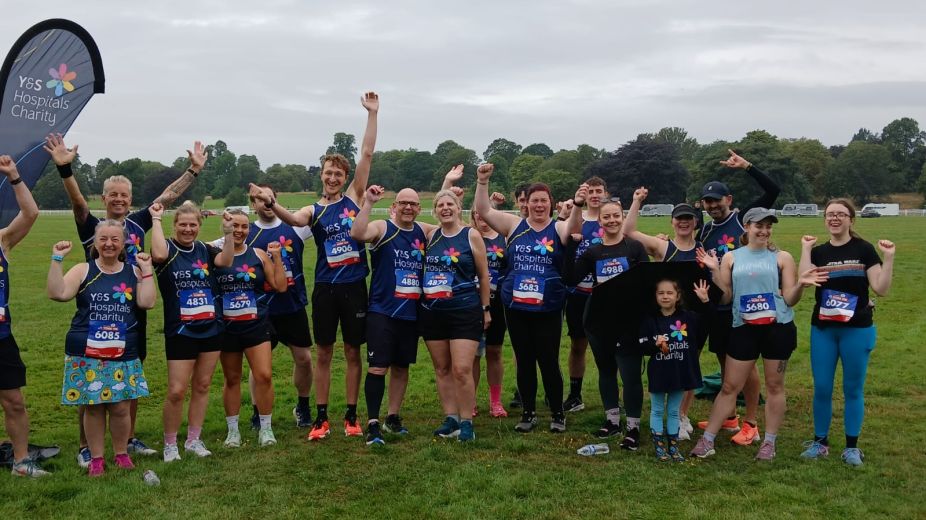 Group of runners posing with medals after completing the York 10k