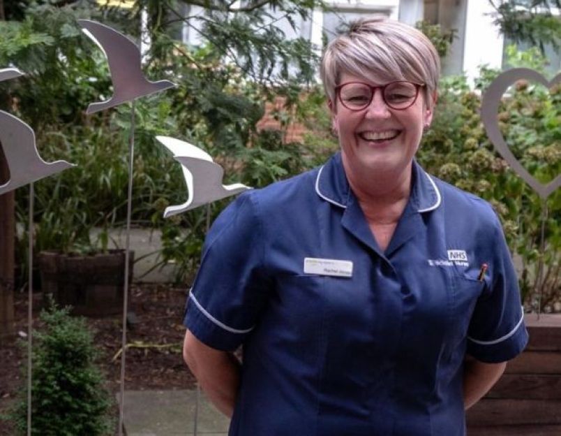 smiling nurse in charity funded garden